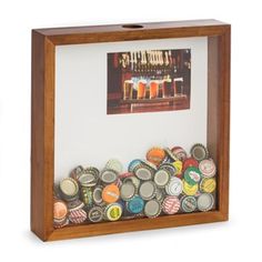 a beer bottle cap display in a wooden frame with glass inserts on the bottom