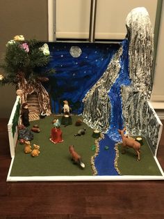 a nativity scene with figurines and toys in the box on the table