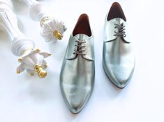 ❣ PRODUCT DESCRIPTION Elevate your style with our Silver Oxford Shoes for Women - a perfect blend of contemporary sophistication and undeniable comfort.  Crafted in stylish metallic vegan leather, these oxfords redefine fashion with a touch of silver brilliance. Designed for all-day wear, these comfortable soft shoes ensure a delightful experience on your birthday or any special celebration.  The pointy toe adds a subtle elegance, making them a fashion-forward choice for the modern woman. Indulg Silver Oxford Shoes, Oxford Shoes Women, Silver Oxfords, Wedding Flats, Chic Shoes, Leather Oxford Shoes, Soft Shoes, Contemporary Chic, Bride Shoes