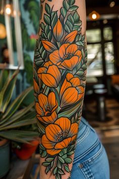 an orange flower tattoo on the arm