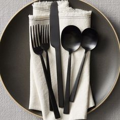 black utensils and napkins on a plate