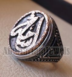 Customized Arabic calligraphy names ring personalized antique jewelry style sterling silver 925 and bronze all size TSB1002 خاتم اسم تفصيل This is made to order item please allow 2 - 3 weeks before shipping . Any name can be applied one or two parts . Please write the name/s in the order notes in Arabic or English . A sketch drawing ( see Pics ) will be sent to you after 2 - 5 days from order before we proceed to production . Ring face dimensions 21 mm X 16 mm Sterling silver 925 is used and bro Antique Engraved Ring With Antique Finish As Gift, Antique Engraved Ring As Gift With Antique Finish, Bronze Engraved Rings For Gift, Antique Bronze Engraved Ring For Gift, Bronze Engraved Rings Ideal For Gifts, Engraved Bronze Rings Gift, Engraved Bronze Rings Ideal For Gifts, Silver Rings With Antique Finish As Gift, Silver Rings With Antique Finish For Gifts