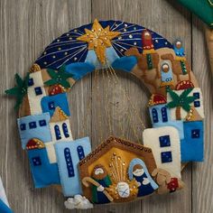 a christmas ornament hanging on the side of a wooden wall with decorations around it