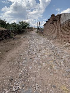 a dirt road that has rocks on it