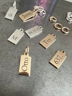 "A sideways display of your name, initials, or a short word makes for an intriguing look with our sleek tag charm. We will engrave your name or message in vertical display on this 14k gold-filled shiny pendant and ring to hang on your own chain. CHAIN NOT INCLUDED Free Engraving for a limited time! CHARM DETAILS * 14k gold-filled or 925 sterling silver * Tag measures 13.5mm x 6mm (.53\" x .23\") * Large jump ring to slide on to your favorite chain * Choice of several fonts and design layouts * U Small Blank Rectangular Sterling Silver Writeable Gift Tag, Design Layouts, Name Tag, Jump Rings, Custom Name, Charm Necklace, Limited Time, Necklace Etsy, Gold Filled