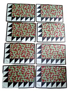 six quilted placemats with red flowers on them