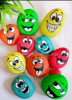 colorful painted rocks with cartoon faces on them