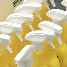 several yellow and white plastic bottles are lined up