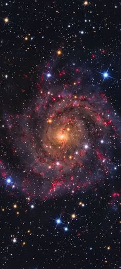 an image of a spiral galaxy in the sky with stars all around it and bright colors