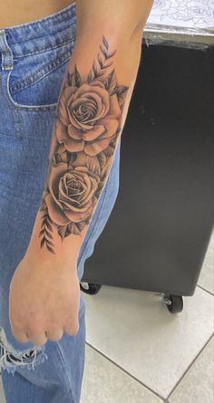 a person with a rose tattoo on their arm