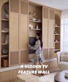 a woman standing in front of a wall unit