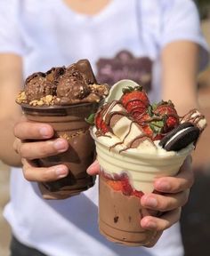 two people holding ice cream and chocolate desserts