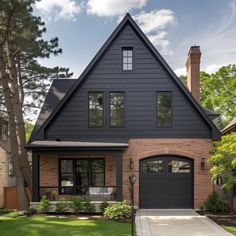 a black house with two garage doors and windows