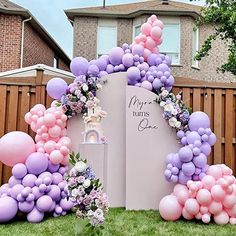 an outdoor birthday party with balloons and flowers