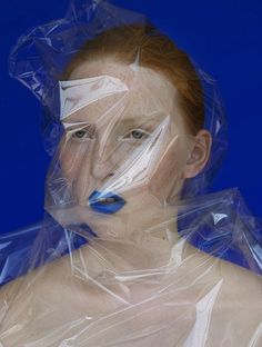 a woman with plastic covering her face and body