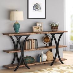 a wooden shelf with books and pictures on it next to a lamp in a room