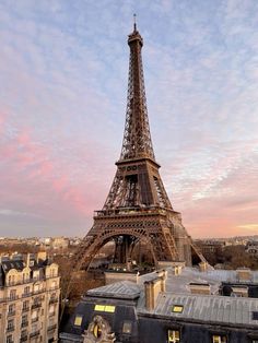 the eiffel tower towering over paris at sunset