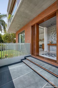 the front door of a house that has a white fence around it