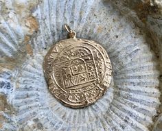 Large Atocha Coin Pendant in 14K Solid Gold. 1.25 Inches/ 30mm in Diameter and 2/3 of an ounce of 14K Gold- Approximately 20 Grams of Gold. Nuestra Señora de Atocha was a Spanish treasure galleon that sank in a hurricane near the Florida Keys in 1622. At the time of her sinking, Atocha was heavily loaded with silver, gold, gems and other treasures bound for Spain. Never made it. The ship was named for the parish of Atocha in Madrid Much of the wreck of Nuestra Señora de Atocha was famously recov Commemorative Gold Jewelry With Large Pendant, Gold Large Pendant Jewelry For Commemoration, Traditional Gold Jewelry For Commemoration, Luxury Gold Jewelry For Commemoration, Ceremonial Coin-shaped Engraved Jewelry, Ceremonial Engraved Coin-shaped Jewelry, Ceremonial Engraved Coin Jewelry, Artisan Oval Gold Jewelry, Ceremonial 14k Stamped Pendant Jewelry