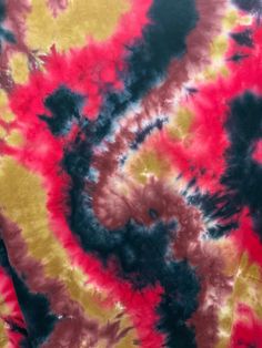 a tie dyed shirt with red, yellow and blue swirls