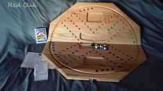 a wooden board game sitting on top of a bed