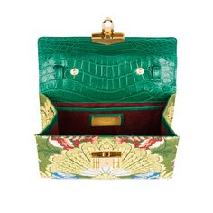 A signature Rubeus jewelled treasure that testifies to the power of classical elegance and Italian artistry. Born as the perfect Christmas present, the Flash Natale dominates all the year around. Small Natale Bag in green millenium crocodile and Luigi Bevilaqua golden and silver threads jacquard with gold-tone hardware and detachable crocodile strap. Three interior slip pockets Measurements : 20x15x5.5 cm Made in Italy Elegant Crocodile Pattern Shoulder Bag As Gift, Green Formal Bag, Elegant Green Formal Shoulder Bag, Green Crocodile Pattern Bag For Formal Occasions, Luxury Crocodile Pattern Bags As Gift, Luxury Green Shoulder Bag For Evening, Luxury Green Formal Shoulder Bag, Luxury Green Bags, Luxury Crocodile Pattern Bags For Gifts