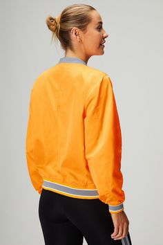 Satin Bomber Jacket Fabletics orange female Activewear >> Womens >> Jackets & Outerwear >> Jackets regular Everyday Bomber jacket in Satin Stretch fabric. Sporty Track Jacket For Spring Workwear, Gym Outerwear With Ribbed Cuffs, Orange Sporty Track Jacket For Streetwear, Orange Sporty Long Sleeve Track Jacket, Sporty Orange Track Jacket For Streetwear, Sporty Orange Outerwear For Streetwear, Orange Outerwear For Sports In Fall, Orange Sporty Windbreaker For Fall, Sporty Orange Windbreaker For Fall