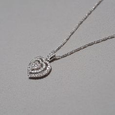 "Love's Shimmering Secret" is a stunning 14k white gold pendant, meticulously crafted to showcase elegance and sophistication. The heart-shaped design of the pendant symbolizes love and affection, making it an ideal gift for someone special or a meaningful self-indulgence. The 14k white gold setting lends a timeless and luxurious quality to the pendant. White gold's lustrous and silvery hue serves as a perfect backdrop to enhance the pendant's brilliance. The pendant features a cluster of shimme Love And Affection, White Gold Pendant, White Gold Set, Someone Special, Quality Diamonds, Gold Pendant, Ideal Gift, White Gold, Pendant