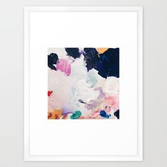 an abstract painting with white, blue and pink colors in black frame on the wall