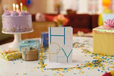 a birthday card sitting on top of a table with confetti and presents around it