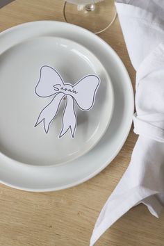 a white plate with a paper bow on it