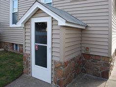 a small house with a white door and window