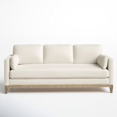 a white couch sitting on top of a wooden frame