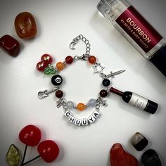 -Handmade Chuuya Nakahara inspired bracelet with dangling charms and name tag -Adjustable with semi-loose fit on smallest setting -Made with stainless steel, acrylic beads, and plastic charms -Take care when handling and do not tug on it, as it is handmade. May appear tangled occasionally but is easy to fix Bungou Stray Dogs Bracelet, Adjustable Novelty Charm Bracelet, Adjustable Charm Bracelet With Removable Dangle Charms, Adjustable Charm Bracelet With Dangle Removable Charms, Adjustable Charm Bracelet With Dangle Charms, Adjustable Charm Bracelet With Dangling Charms For Friendship, Unique Adjustable Charm Bracelet, Adjustable Friendship Charm Bracelet With Dangling Charms, Personalized Adjustable Dangle Charm Bracelet