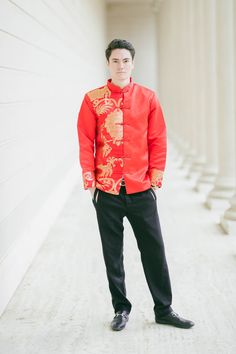 "An exquisite and comfortable red jacket decorated with a gold dragon to symbolize good luck for the marriage. This changshan is the male equivalent of the classic red cheongsam. Matches well with the Emma and Amal Dresses (https://eastmeetsdress.com/collections/modern-cheongsams/products/emma-bespoke-dress). Check out our other jackets and changshans at www.eastmeetsdress.com. The Details: - Mandarin collar with frog buttons - Made of brocade fabric - Breathable, comfortable formal wear - Full Winter Ceremony Long Sleeve Outerwear, Embroidered Long Sleeve Outerwear For Ceremony, Red Festive Outerwear With Stand Collar, Festive Red Outerwear With Stand Collar, Red Long Sleeve Outerwear For Wedding, Red Ceremonial Winter Outerwear, Ceremonial Red Winter Outerwear, Fitted Red Ceremonial Outerwear, Fitted Red Outerwear For Ceremonial Occasions