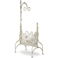 an ornate metal magazine rack with two candles on it's sides and one candle holder in the middle