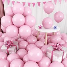 a room filled with pink balloons and presents