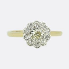 Here we have a delightful antique diamond cluster ring. A single round faceted old cut diamond sits at the centre of a platinum face and is surrounded by an array of slightly smaller matching old cut diamonds around the outer edge. All stones have been set within a fine milgrain edging and collectively mimic the shape of a daisy flower atop an 18ct yellow gold band. Condition: Used (Very Good) Weight: 2.2 grams Ring Size: L (52) Band Width: 1mm Face Dimensions: 9mm x 9mm Centre Diamond Weight: A A Daisy Flower, Daisy Ring, Antique Diamond, Diamond Cluster Ring, Diamond Cluster, Cluster Ring, Ring Box, Daisy Flower, Rings Statement