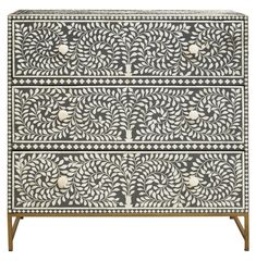 an intricately decorated chest with two drawers and one drawer on the bottom, in white and