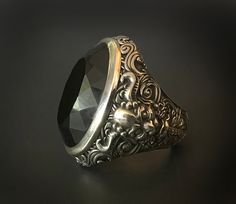 RING PROFILE: 🔱This Devil's Dark Soul ring is an impressive & powerful statement ring throughout. Its majestic, mystical and mighty appearance truly demands attention. The intricate floral demon design on the ring band seamlessly complements the dark agate stone and heightens its mystic allure. 🔱Embellished with an exquisite solid Black Agate or Rainbow Eye Obsidian gemstone customizable with either a round cabochon or a facetted cut. The elaborately ornamented ring band design is inspired by Luxury Oval Carved Rings, Elegant Formal Skull Ring With Polished Finish, Luxury Silver Skull Ring For Formal Occasions, Unique Gemstone Engraved Ring For Formal Occasions, Elegant Silver Skull Ring With Gemstone, Luxury Handmade Silver Emerald Ring, Luxury Large Stone Crystal Ring For Formal Occasions, Handmade Luxury Crystal Ring For Formal Occasions, Handmade Luxury Silver Emerald Ring