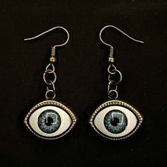 Please read descriptions thoroughly for sizes and materials.  This is a pair of earrings with eerily realistic blue resin eyeballs with a bronze bezel that seem to always be looking at you. They are a really fun and a little spooky! They are hung from standard hypoallergenic ear wires. Earrings are also available to be hung on 925 Sterling Silver ear wires, clip ons, 16-18mm Surgical Steel Hoops or 12-14mm Surgical Steel Hoops. Make sure to check out my shop for more hair pins, jewelry, earrings Novelty Metal Earrings With Ear Wire, Eyeball Bracelet, Blue Handmade Novelty Earrings, Handmade Blue Novelty Earrings, Novelty Blue Drop Earrings, Eyes Creepy, Eyeball Necklace, Bohemian Adjustable Eye-shaped Jewelry, Blue Round Evil Eye Earrings