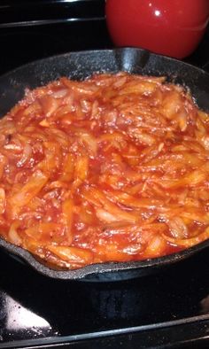 a skillet filled with food sitting on top of a stove