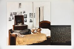 a woman laying on top of a bed next to a wall with pictures and writing