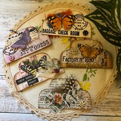 some butterflies and tags are sitting on a doily