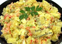 a black bowl filled with potato salad on top of a table