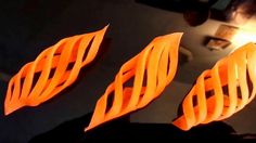 three orange pieces of plastic sitting on top of a table