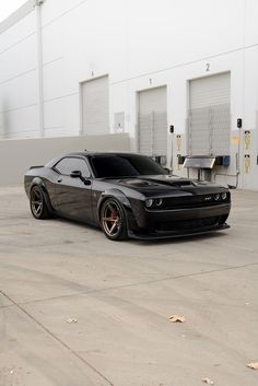 a black sports car parked in front of a building