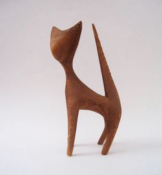 a wooden cat figurine on a white background