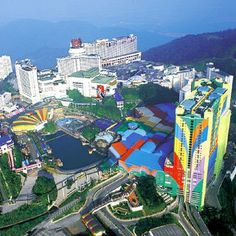 an aerial view of a city with lots of tall buildings and colorfully painted structures