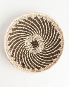 a brown and white basket sitting on top of a table